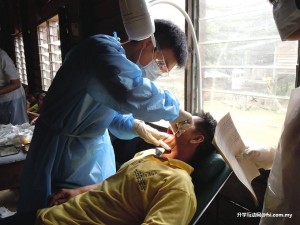Dr. Lee performing dental check-up on one of the villagers.
